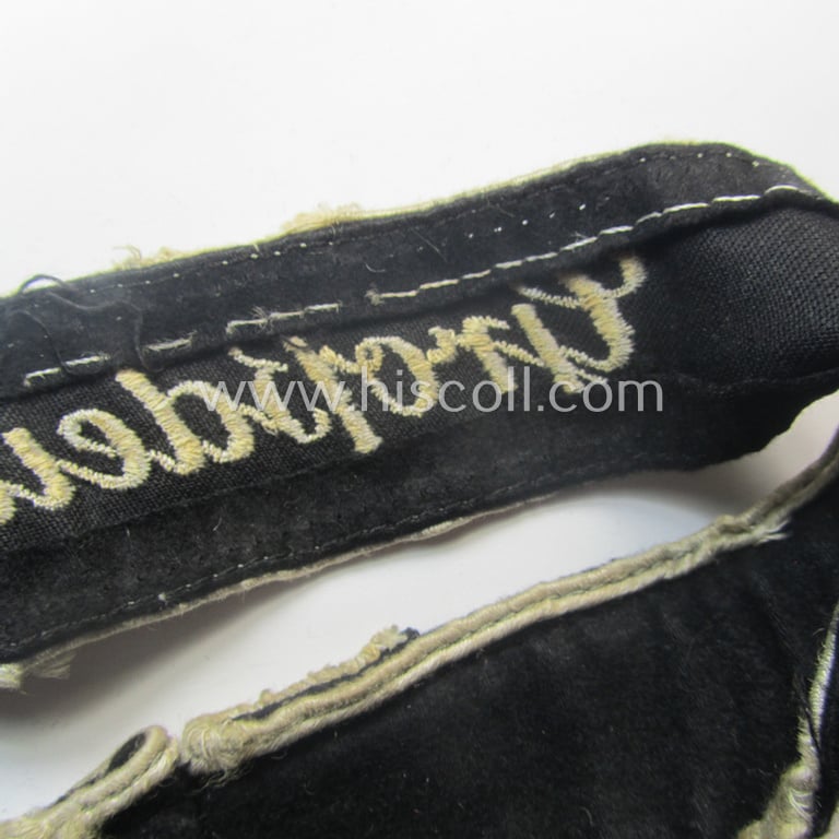Truly used- and/or worn example of a WH (Heeres) cuff-title ie. armband (ie. 'Ärmelstreifen') entitled: 'Grossdeutschland' (being a neatly machine-embroidered example of the third pattern that was specifically intended for EM- ie. NCO-usage)
