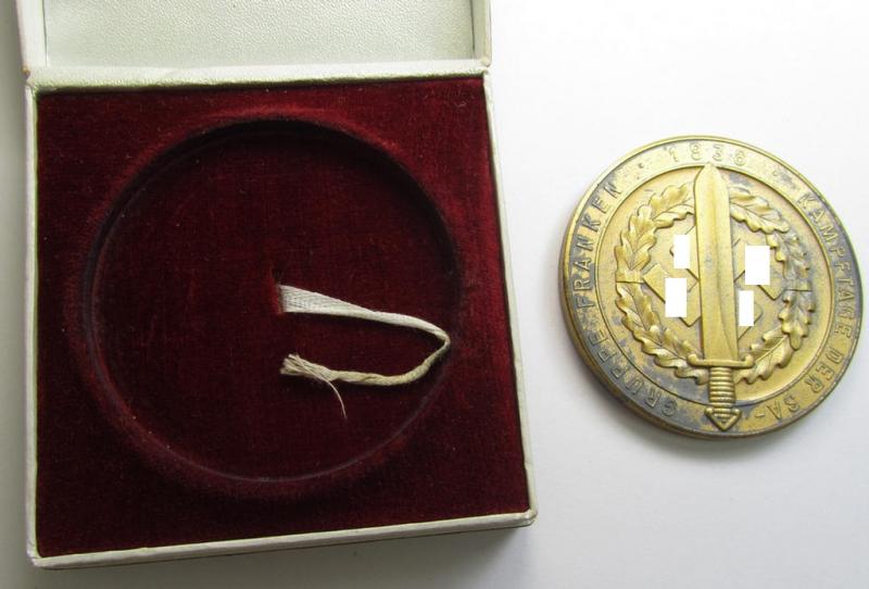 Attractive, golden-toned- (ie. 'Feinzink'-based) so-called: SA- ie. ('Sturmabteilungen'-) related, commemorative-plaque entitled: 'Kampftage der SA - Gruppe Franken - 1938' and showing the text: 'Dem 1. Sieger' and that comes in its period et...
