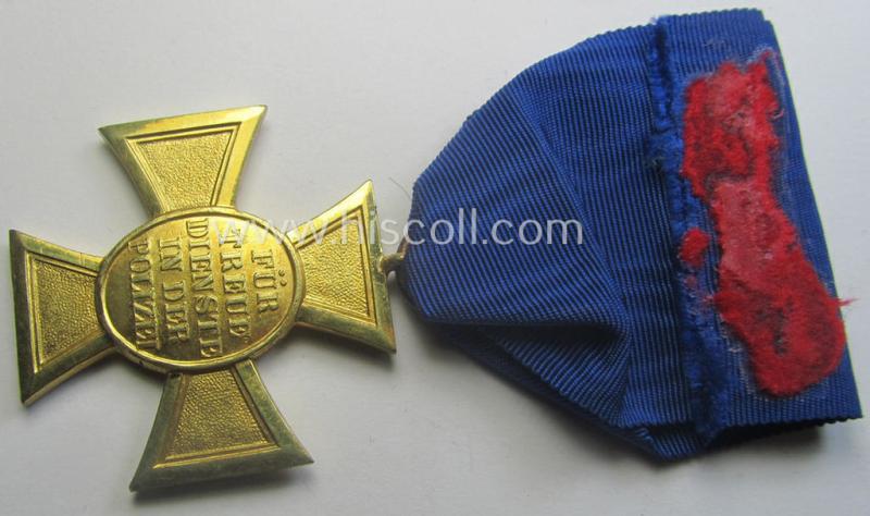 Golden-class 'Pol.-Dienstauszeichnung 1. Stufe' (or: police loyal-service medal first-class) that comes mounted onto its (typically broader-shaped) ribbon (ie. 'Bandabschnitt')