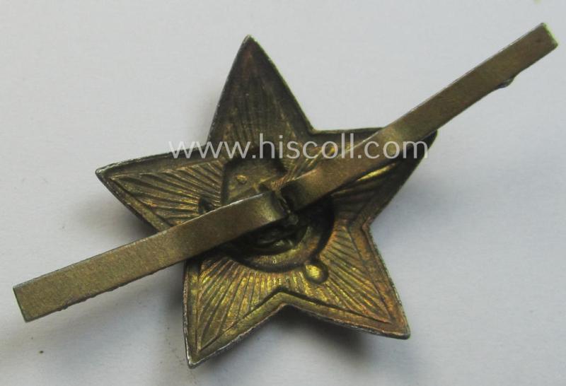 Unusal item that originated from a German soldier: a Russian, smaller-sized and/or WWII-period, enamelled star-shaped cap-badge showing the communist logo on a bright-red-coloured surface