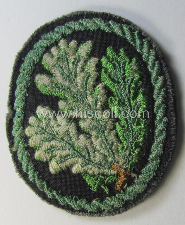 Attractive example of a WH (Heeres) so-called: 'Jäger'-armbadge being a neatly machine-embroidered- and/or multi-coloured version as was executed on darker-green-coloured wool