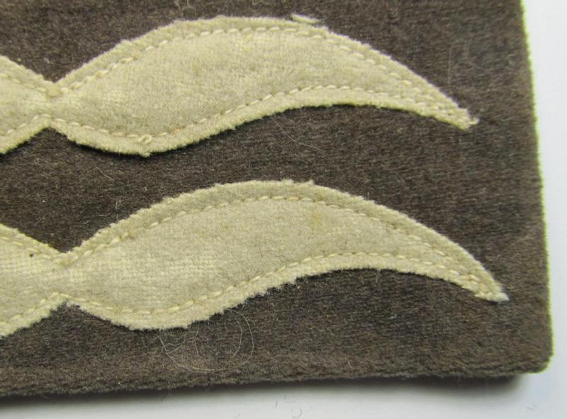 Single - but nevertheless scarcely found! - WH (LW) light-blue-coloured- and/or woolen-based, NCO-type rank-patch (aka 'moustache') as was specifically intended for usage by a non-commissioned officer holding the rank of: 'Feldwebel' (ie. sergean...