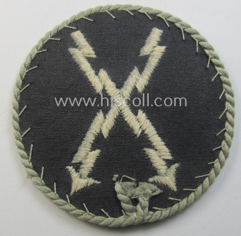 Attractive - and hardly used! - example of a WH (Luftwaffe) machine-embroidered, trade- ie. special-career-patch (ie. 'Tätigkeitsabzeichen') having a silverish-grey-toned 'Kordel' attached as was intended for: 'LW-Fernschreib-Unteroffiziere'