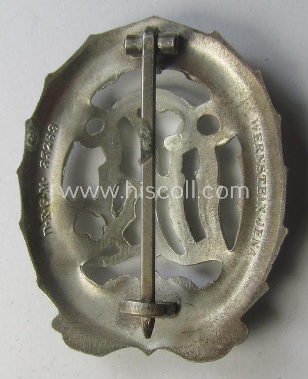 'Virtually mint' example of a: 'Reichssportabzeichen DRL in Silber' (or: DRL sports'-badge in silver) being a just moderately worn- ie. used example that is nicely maker- (ie. 'Wernstein - Jena'-) marked on its back