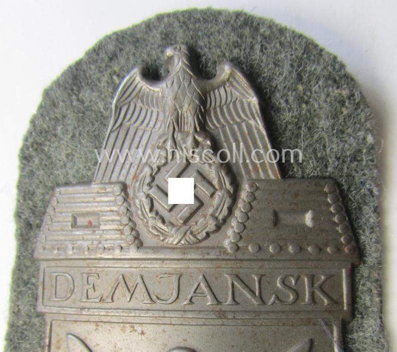 Superb - and fairly scarcely encountered! - example of a WH (Heeres ie. Waffen-SS) 'Demjansk'-campaign-shield as executed in typical magnetic metal (ie. so-called: 'Eisenblech') and that comes in an overall very nice- ie. fully untouched, conditi...