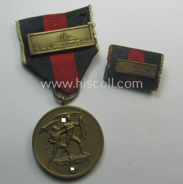 WH Czech-occupation- (ie. 'Anschluss'-) medal: '1. Oktober 1938' that comes with its period-attached 'PB-Spange' (and ribbon-bar) and that comes stored in its bordeaux-red-coloured- and/or non-maker-marked etui