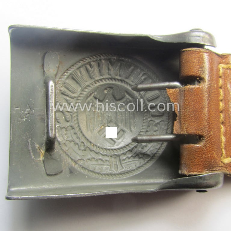 WH (Heeres) 'standard-pattern', field-grey-toned- and steel-based belt-buckle being a maker- (ie. 'H. Arld - Nuernberg'-) marked- and/or: '1941'-dated example that comes mounted onto its leather-based tab