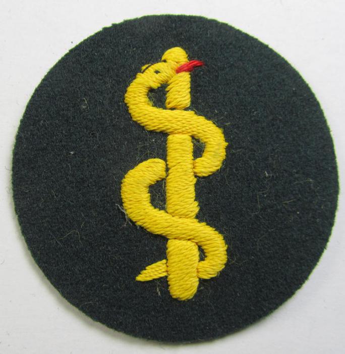 WH (Heeres) so-called trade- and/or special-career insignia (or: 'Heeres-Tätigkeits- abzeichen') as was intended for: 'Sanitätspersonal' (or medical orderlies- ie. staff)