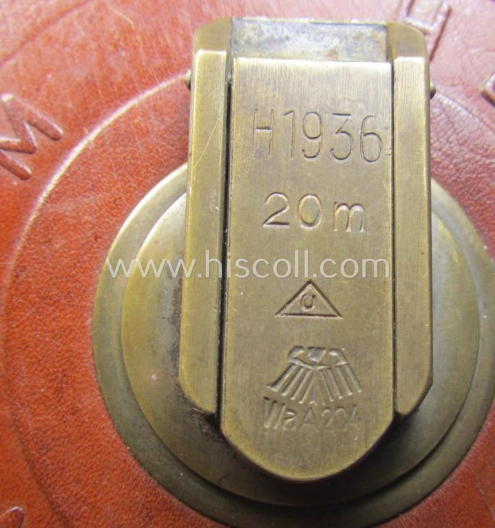 Attractive, 'high-quality'-produced, WH (Heeres) measuring-device (ie. 'tape-ruler') being a complete and fully functional example that is neatly marked: 'Heereseigentum' and that is clearly dated: 'H 1936'