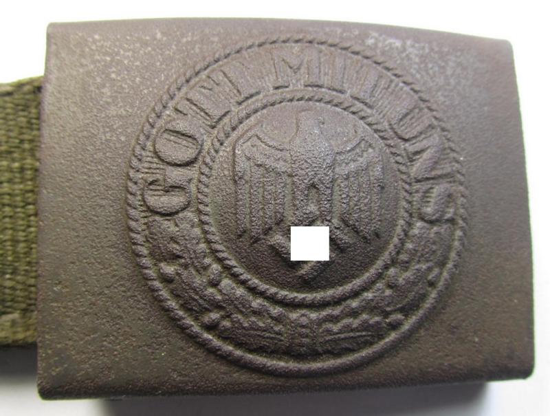 Neat, WH (Heeres) 'tropical-issued' belt-buckle (being a non-maker-marked and/or typical olive-green-coloured) example that comes mounted onto its original, greenish-coloured (and/or: 'webbing'-based-) tab