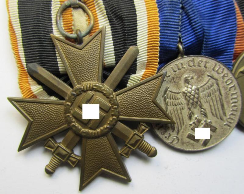 Attractive example of a three-pieced medal-bar (ie.: 'Ordenspange') resp. showing a: 'KvK 2. Klasse mit Schwertern', a: 'WH-DA 4. Stufe' (with firmly attached eagle-device) and a Czech 'Anschluss'-medal '1 Oktober 1938'