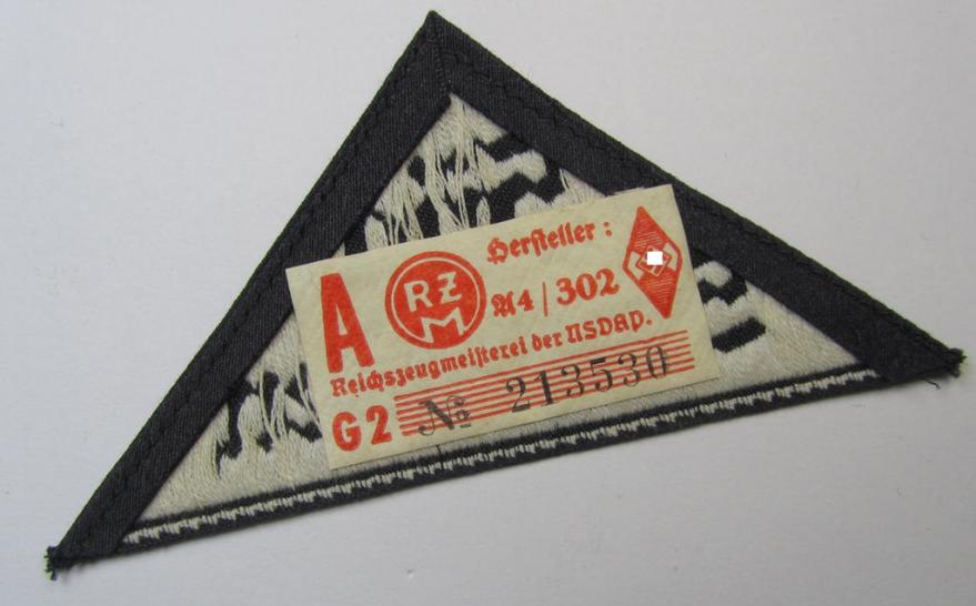 Attractive, 'HJ' ('Hitlerjugend') ie. 'BDM' ('Bund Deutscher Mädel'-) district-triangle (ie. 'Gebietsdreieck') entitled: 'Süd Schwaben' (being a never worn example that still retains its period-attached 'RzM'-etiket)