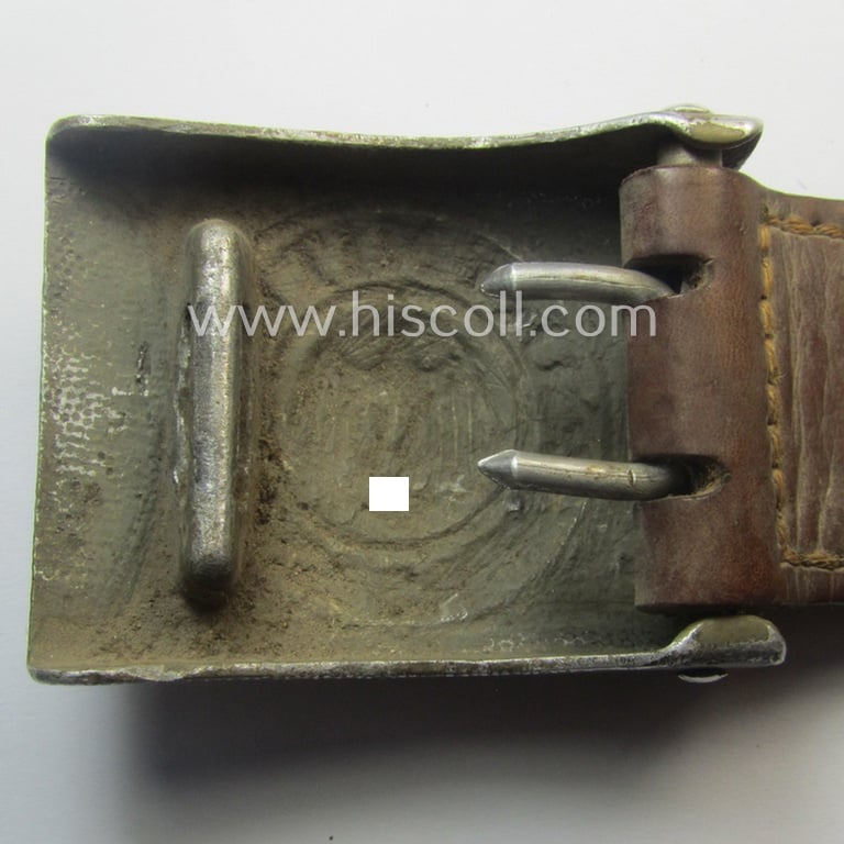 WH (Heeres) 'standard-pattern', field-grey-toned- and aluminium-based belt-buckle being a maker- (ie. 'Hermann Knoller - Pforzheim'-) marked- and/or: '1939'-dated example that comes mounted onto its leather-based tab