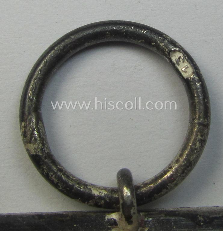 'Eisernes Kreuz II. Klasse' being a maker- (ie. '13'-) marked example that comes together with its confectioned ribbon (ie. 'Bandabschnitt') as was produced by the maker (ie. 'Hersteller'): 'Gustav Brehmer'