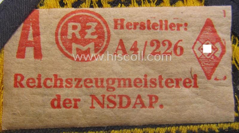 'HJ' ('Hitlerjugend') district-triangle (ie. 'Gebietsdreieck') entitled: 'Reichs-deutsche Jugend Ausland' being an (I deem) minimally worn- ie. used specimen that retains its 'RzM'-etiket