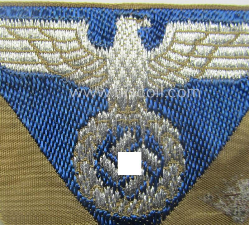 SA-related cap-eagle as was intended for the: 'Lagermütze' (ie. side-cap) being an example as woven on a typical bright-blue-coloured background and as such intended for members within the: 'SA-Gruppe Warthe o. Oberrhein'