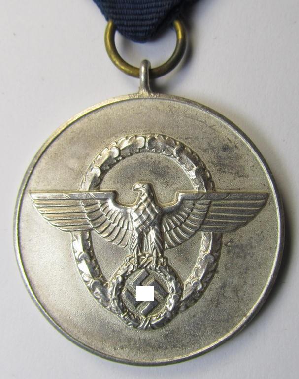 Moderately worn, bright-silver-toned, so-called: 'Polizei-Dienstauszeichnung 3. Stufe' (or: police loyal-service medal third-class) that comes mounted onto its period ribbon (ie. 'Bandabschnitt')