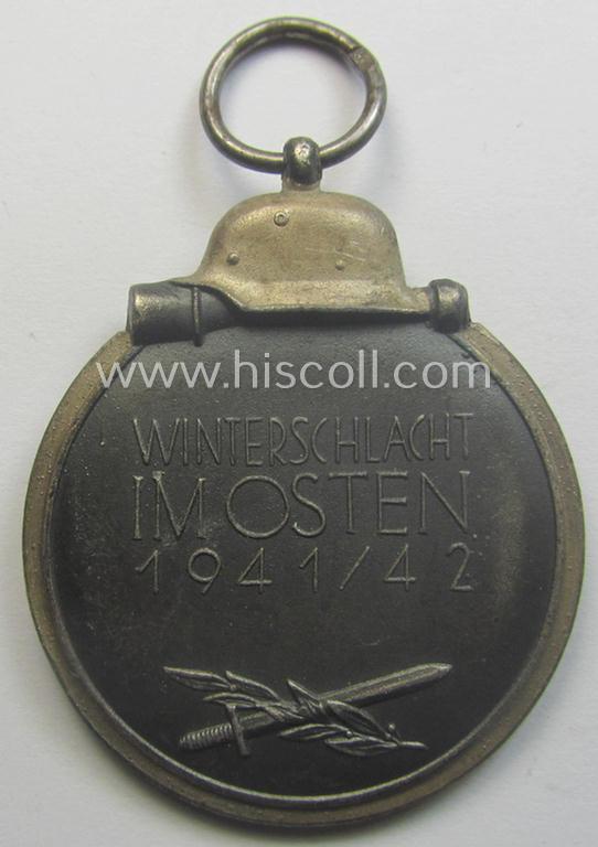 Medal-set: 'Winterschlacht im Osten 1941-42' being a maker- (ie. '93'-) marked- (and/or 'Feinzink'-based) specimen by the maker: 'Richard Simm & Söhne' and that comes together with its (minimally confectioned) ribbon (ie. 'Bandabschnitt')