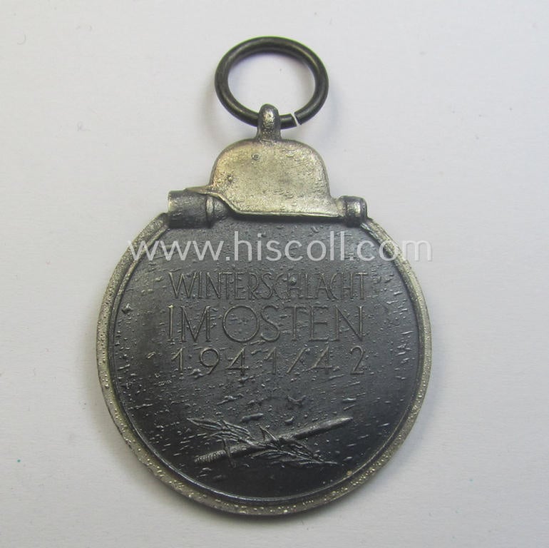 Medal-set: 'Winterschlacht im Osten 1941-42' being a non-maker-marked- (and/or 'Feinzink'-based) specimen that comes together with its (minimally confectioned) ribbon (ie. 'Bandabschnitt')