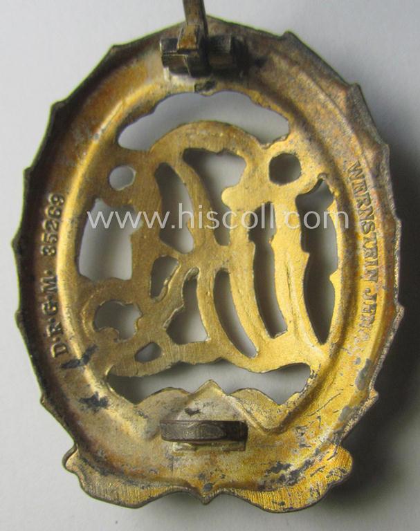 'Reichssportabzeichen DRL in Gold' (or: golden class DRL sports'-badge) being a just moderately worn- ie. used example that is nicely maker- (ie. 'Wernstein - Jena'-) marked on its back