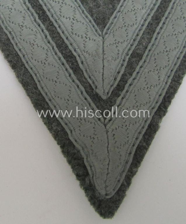 WH (Heeres) 'Armwinkel' (or: arm-chevron) as executed on typical field-grey-coloured wool as was specifically intended for usage by a soldier with the rank of: 'Obergefreiter'