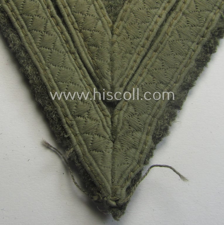 WH (Heeres) 'Armwinkel' (or: arm-chevron) as executed on typical field-grey-coloured wool as was specifically intended for usage by a soldier with the rank of: 'Obergefreiter'