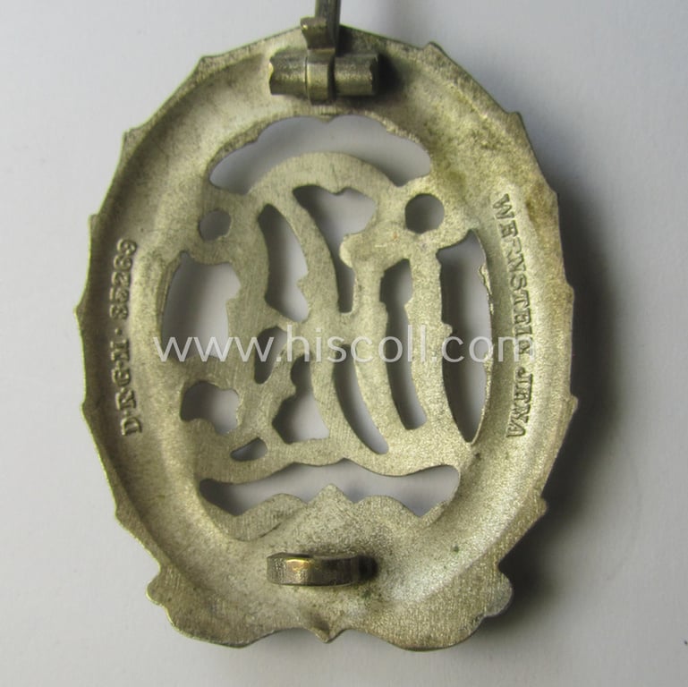 'Reichssportabzeichen DRL in Silber' (or: DRL sports'-badge in silver) being a just moderately worn- ie. used example that is nicely maker- (ie. 'Wernstein - Jena'-) marked on its back