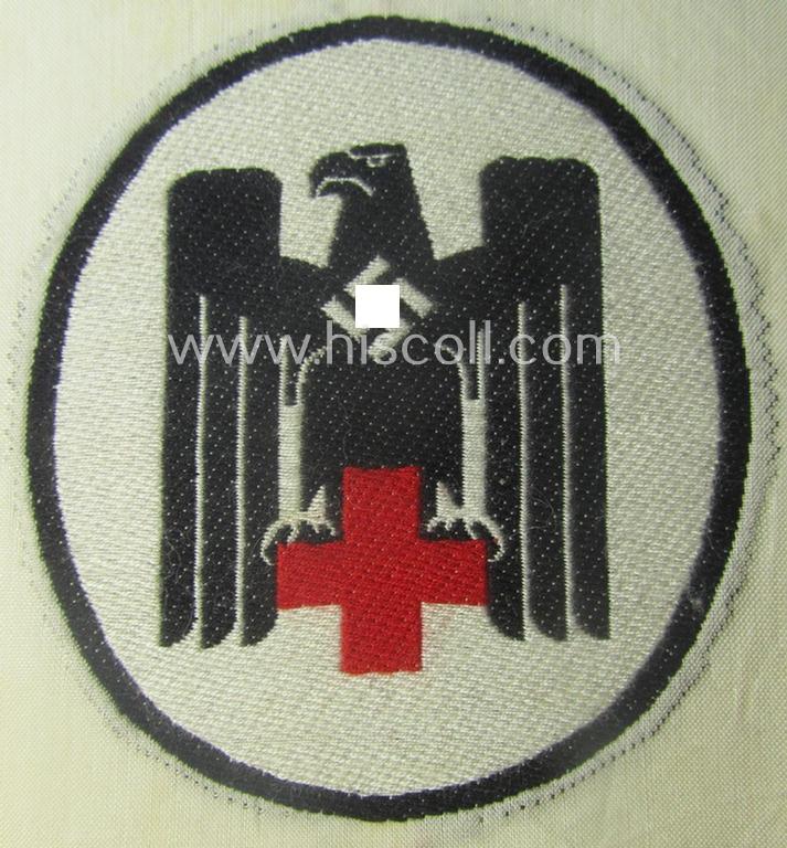 Neat - and actually scarcely encountered! - somewhat larger-sized DRK- (ie. 'Deutsches Rotes Kreuz'-) related sport-shirt emblem as was executed in the neat 'BeVo'-weave-pattern and that comes in a 'virtually mint' condition