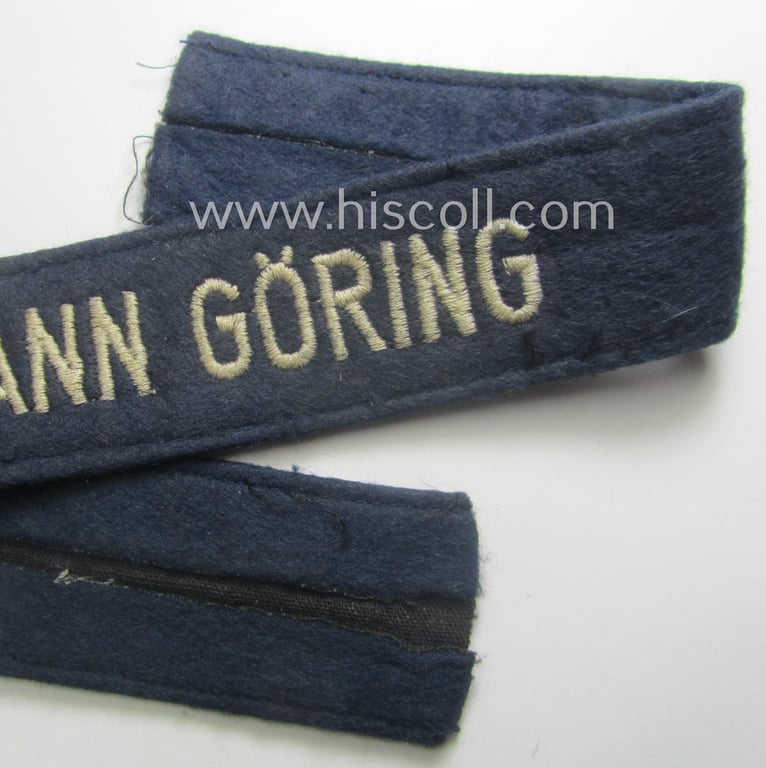 Truly used- and/or tunic-removed, typical 'smooth-woolen'-based, EM- (ie. NCO-) pattern WH (Luftwaffe) cuff-title (ie. 'Ärmelstreifen') entitled: 'Hermann Göring' that comes in that comes in an overall very nice condition
