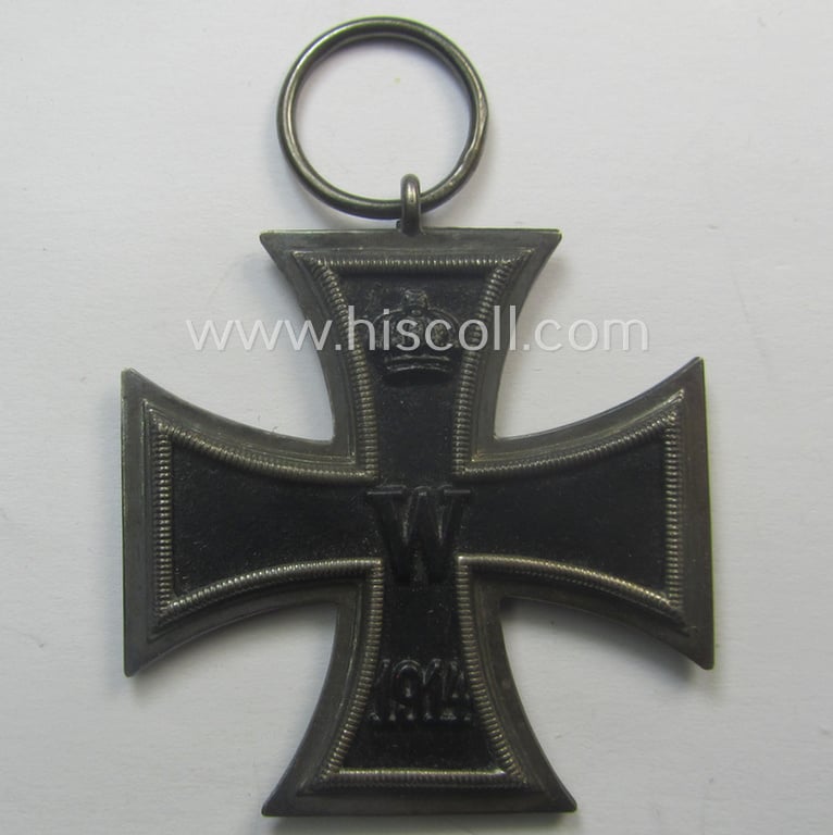 WWI-period: 'Eisernes Kreuz II. Klasse' (or: iron cross second class) being a maker- (ie. 'KO'-) marked example that comes together with its (minimally) confectioned piece of ribbon (ie. 'Bandabschnitt')