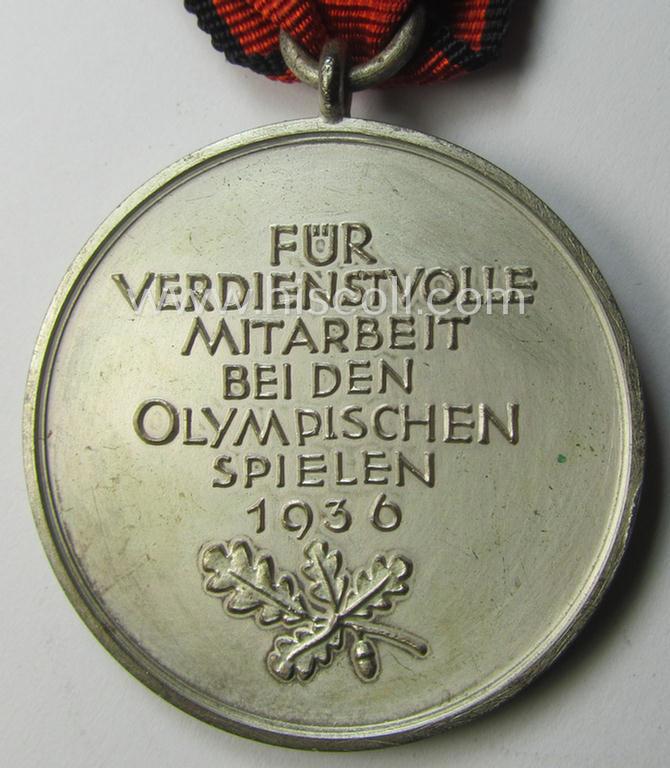 'Deutsche Olympia-Erinnerungsmedaille 1936' being a non-maker-marked example that comes mounted onto its original ribbon (ie. 'Bandabschnitt') and that comes stored in its typical, beige-white-coloured etui