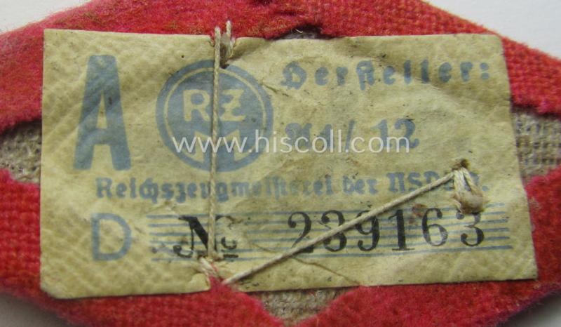 SA- (ie. 'Sturmabteilungen'-) related, aluminium-based cap- (ie. 'Kepi'-) device that came mounted onto its bright-pink-toned, 'Raute'-shaped 'backing' (that still shows its period-attached 'RzM'-etiket)