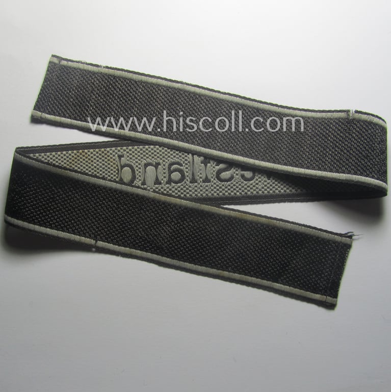Waffen-SS, 1943/44 pattern cuff-title (ie. 'Ärmelstreifen') depicting the machine-woven Latin script text in silver-grey linnen as was intended for a member of the: 'SS-Regiment': "Westland" (ie. part of the: '5. SS-Pz-Gren.-Div. "Wiking")