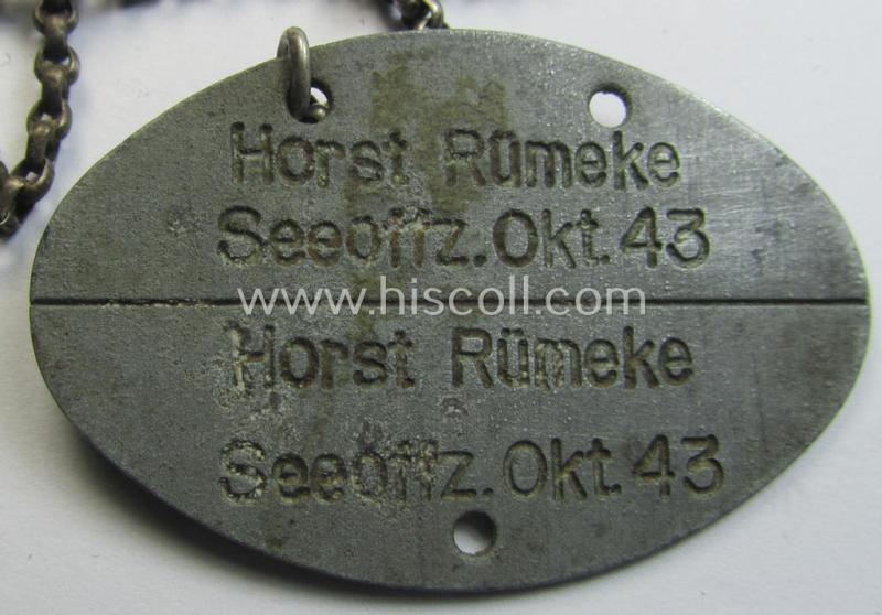 Mid-war- (albeit 'standard-issue'-) pattern, WH (Kriegsmarine) typical zinc- (ie. 'Feinzink'-) based- and greyish-toned ID-disc (ie. 'Erkennungsmarke') bearing the engraved numeral (ie. date) that reads: 'Horst Rümeke - Seeoffz. Okt. 43'