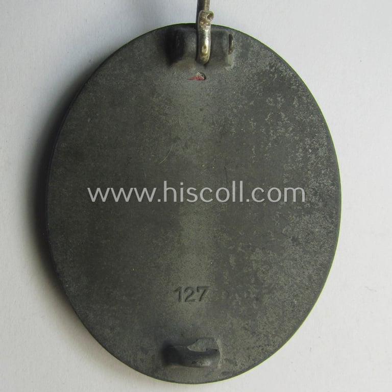 Unusual, silver-class wound-badge (or: 'Verwundeten-Abzeichen in Siber') being a maker- (ie. '127'-) marked example that comes stored in its original (damaged), carton-based pouch by the maker (ie. 'Hersteller'): 'Moriz Hausch A.-G.'