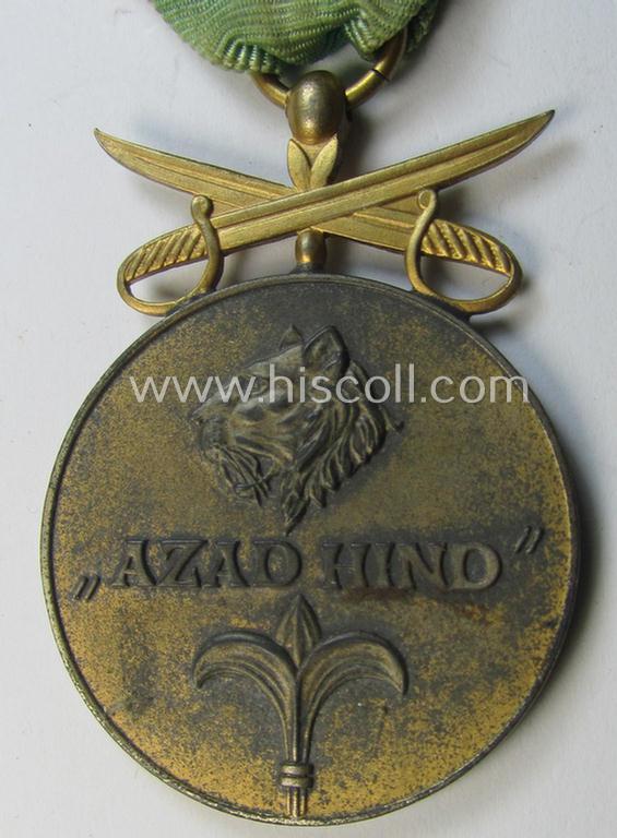 Attractive, WH-related so-called: 'Azad Hind - Goldene Tapferkeits-Medaille mit Schwerten' (being a typical non-maker-marked- and/or: 'Feinzink'-based example that comes mounted onto its period ribbon)
