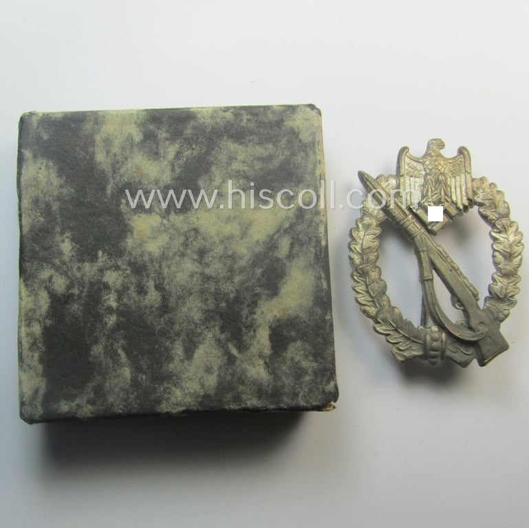 Attractive, 'Infanterie Sturmabzeichen in Silber' (or: silver-class infantry assault-badge ie. IAB) being a maker- (ie. 'ÜÜ'- ie. 'E.F. Wiedmann') marked so-called: 'Lily Pad-hinge'-example that comes stored in its period box