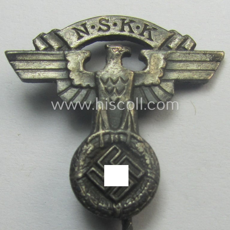 Silver-toned - and 'Feinzink'-based - lapel-pin (ie. 'Zivilabzeichen') being a maker- (ie. 'RzM M1/72'-) marked example to be worn on the civil attire by the various staff-members of the N.S.K.K. (ie. 'National Soc. Kraftfahr Korps')