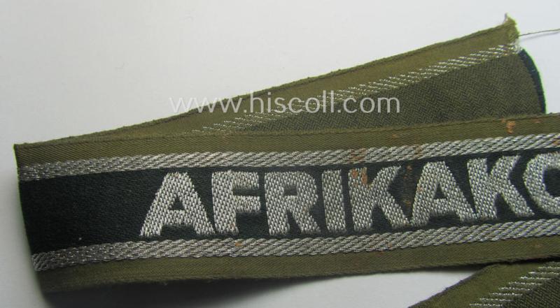 'BeVo'-like cuff-title (ie. 'Ärmelstreifen') entitled: 'Afrikakorps' being a presumably issued but simply never worn example that comes in an overall very nice- (ie. non-shortened- and never tunic-attached-), condition