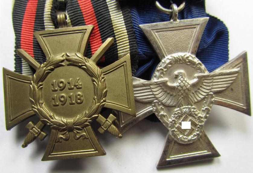 Two-pieced medal-bar (ie. 'Doppelspange') respectively depicting a WWI-period: 'Frontkämpferkreuz 1914-18' (ie.: 'Kriegsteilnehmerkreuz mit Schwerter') and a detailed: 'Polizei-Dienstauszeichnung 2. Stufe'