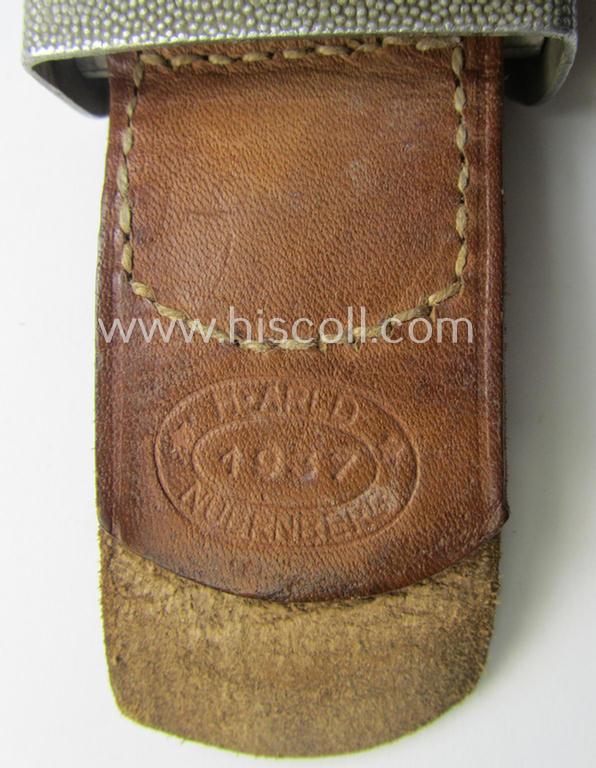 WH (Heeres) 'standard-pattern', field-grey-toned- and aluminium-based belt-buckle being a maker- (ie. 'H. Arld - Nuernberg'-) marked- and/or: '1937'-dated example that comes mounted onto its leather-based tab