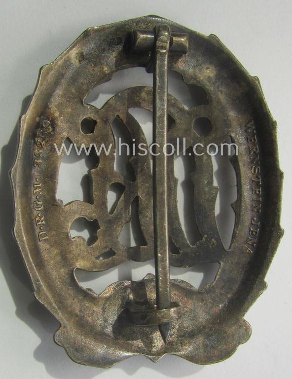 'Reichssportabzeichen DRL in Silber' (or: DRL sports'-badge in silver) being a just moderately worn- ie. used example that is nicely maker- (ie. 'Wernstein - Jena'-) marked on its back