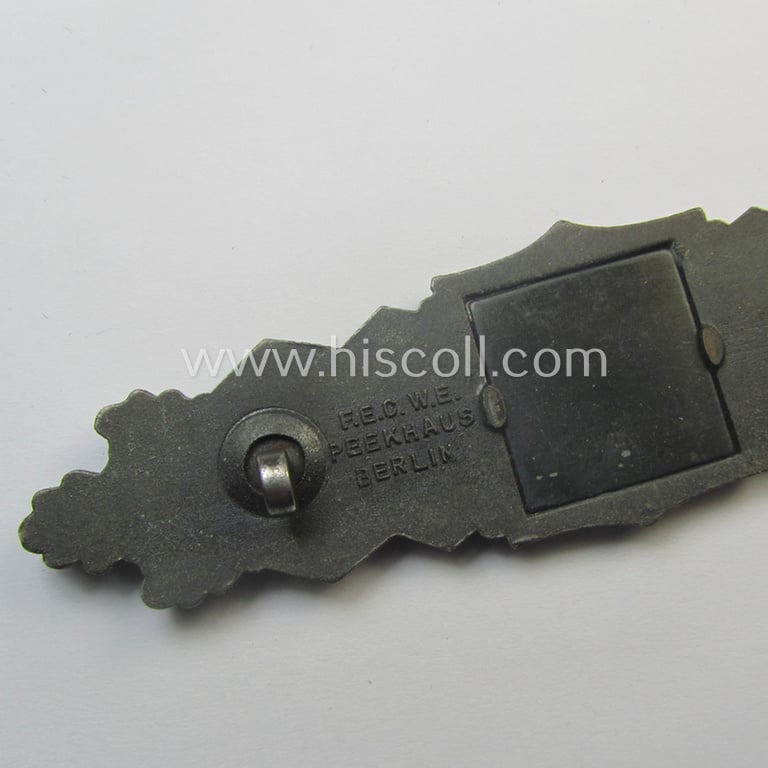 'Nahkampfspange in Bronze' (or: bronze-class close-combat clasp ie. CCC) being a neatly maker-marked- and/or minimally converse-shaped specimen as was produced by the: 'JFS'- (ie. 'Joseph Feix u. Söhne'-) company