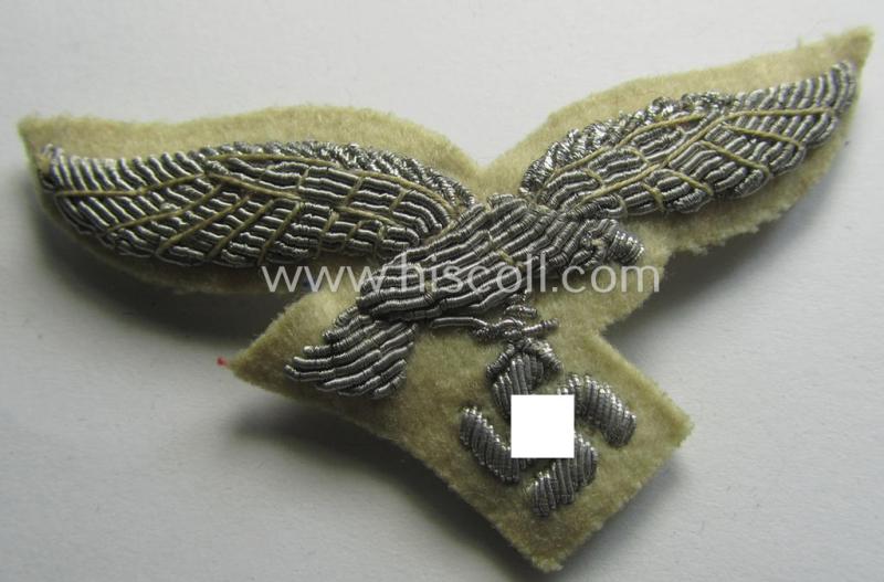 WH (Luftwaffe) officers'-type visor-cap eagle that is neatly hand-embroidered on beige-white-coloured wool as was specifically used for the white-topped LW officers'-type visor-caps (ie. 'Sommer-Schirmmützen')
