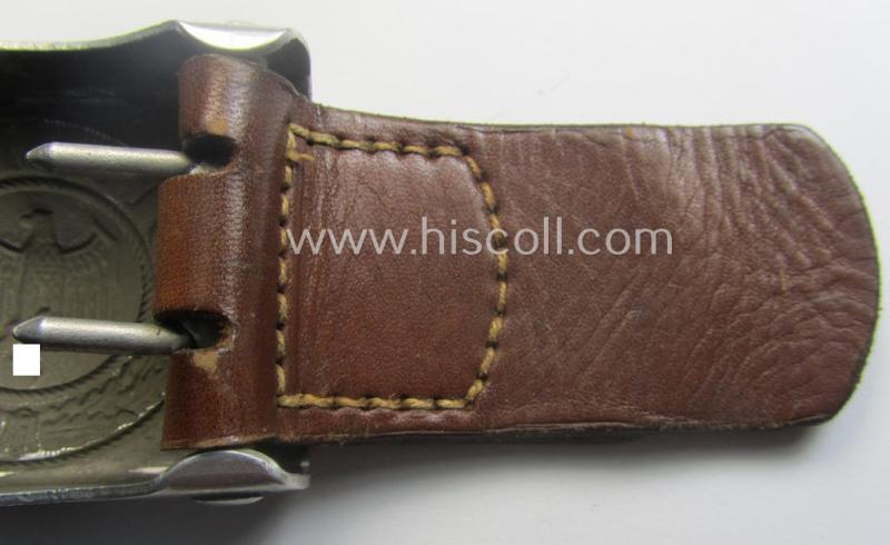 WH (Heeres) 'standard-pattern', field-grey-toned- and aluminium-based belt-buckle being a maker- (ie. 'Jul. Kremp'-) marked- and/or: '1939'-dated example that comes mounted onto its leather-based tab