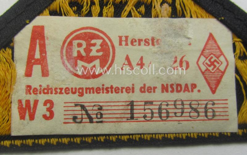 'HJ' ('Hitlerjugend') district-triangle (ie. 'Gebietsdreieck') entitled: 'Reichs-deutsche Jugend Ausland' being a 'virtually mint- ie. unissued' specimen that retains its 'RzM'-etiket