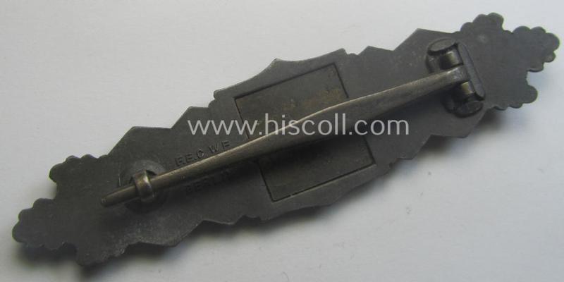 'Nahkampfspange in Bronze' (or: bronze-class close-combat clasp ie. CCC) being a neatly maker-marked- and/or minimally converse-shaped specimen as was produced by the: 'JFS'- (ie. 'Joseph Feix u. Söhne'-) company