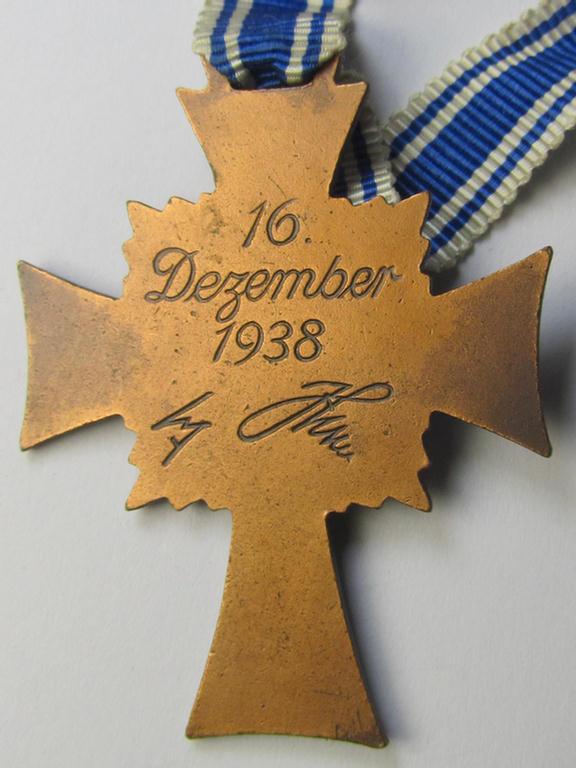 Attractive, 'Ehrenkreuz der deutschen Mutter - dritte Stufe' (or: bronze-class mothers'-cross) that came mounted onto its long-sized ribbon and that came stored in its period pouch (by the maker: 'Jakob Bengel - Idar-Oberstein')