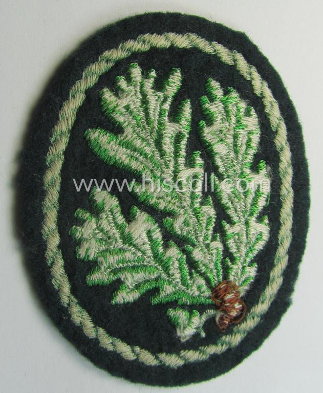 Attractive example of a WH (Heeres) so-called: 'Jäger'-armbadge being a neatly machine-embroidered- and/or multi-coloured version as was executed on darker-green-coloured wool