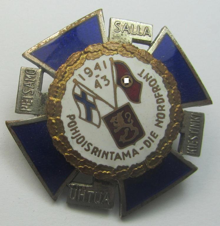 Finnish-/German: 'Nordfrontkreuz', being a white-/blue-coloured and maker- (ie. 'Hopeatakomo o.y.'-) marked 'variant' that shows the text: 'Pohjoisrintama - Die Nordfront - 1941/43'